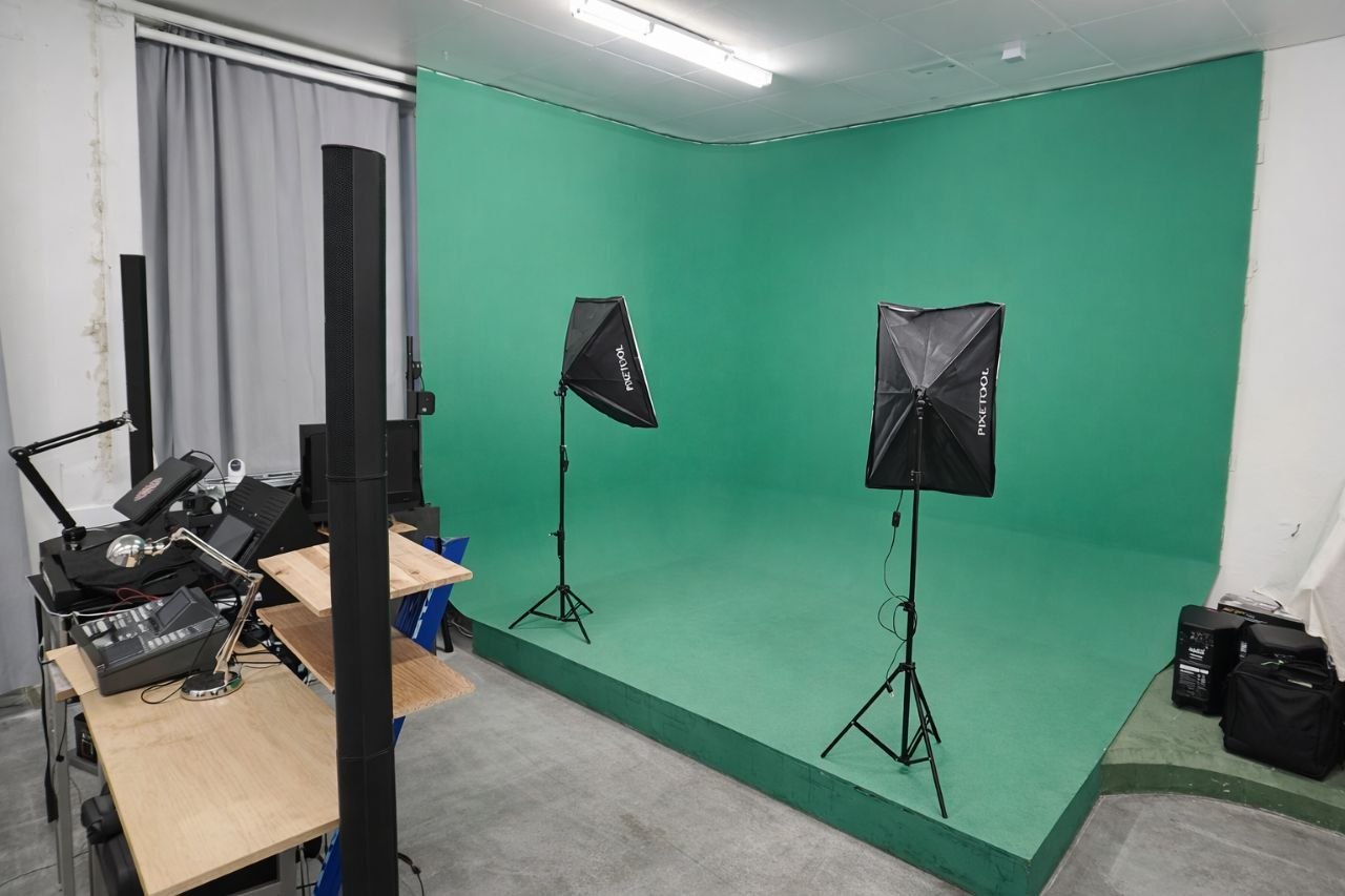 Green-screen corner and floor with two softbox lights at Sector 7G Studios
